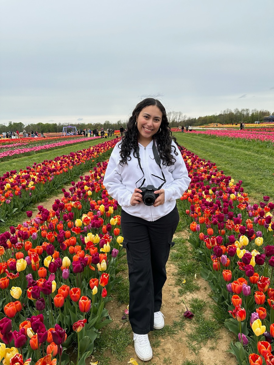 Nicole holding her camera in a tulip field