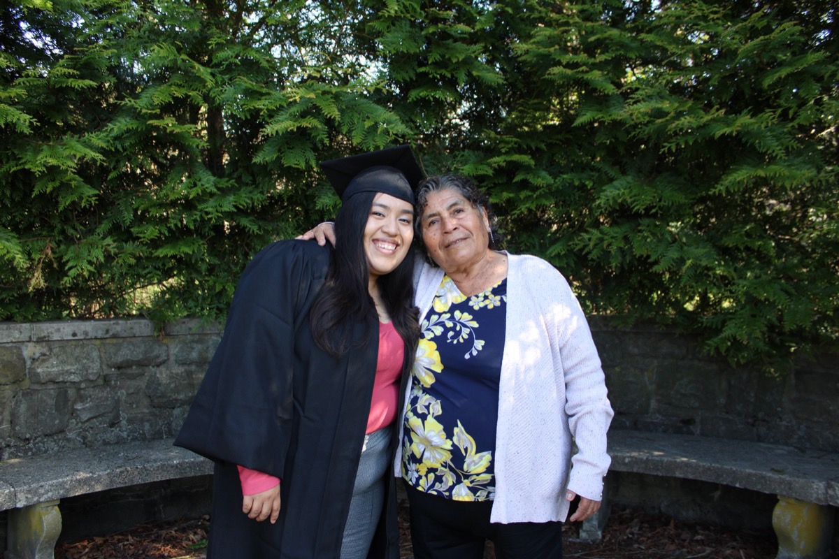 Graduate portrait among yellow daffodils